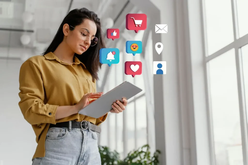 Mulher usando tablet com ícones de redes sociais flutuando ao redor, representando a integração de redes sociais em sites.