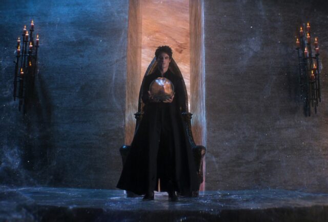 Morpheus the Endless Lord of the Dreaming, standing in black robes while holding a talisman