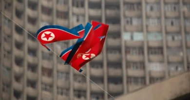 EUA sancionam rede de TI da Coreia do Norte; bandeira em Pyongyang simboliza tensão diplomática e sanções cibernéticas