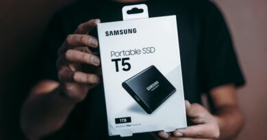 Close-up of a person holding a Samsung T5 Portable SSD box, emphasizing modern technology.