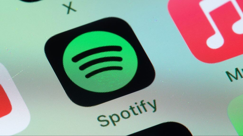 Spotify lança letras offline e tradução global 2 Tela de smartphone mostrando Spotify e Apple Music.